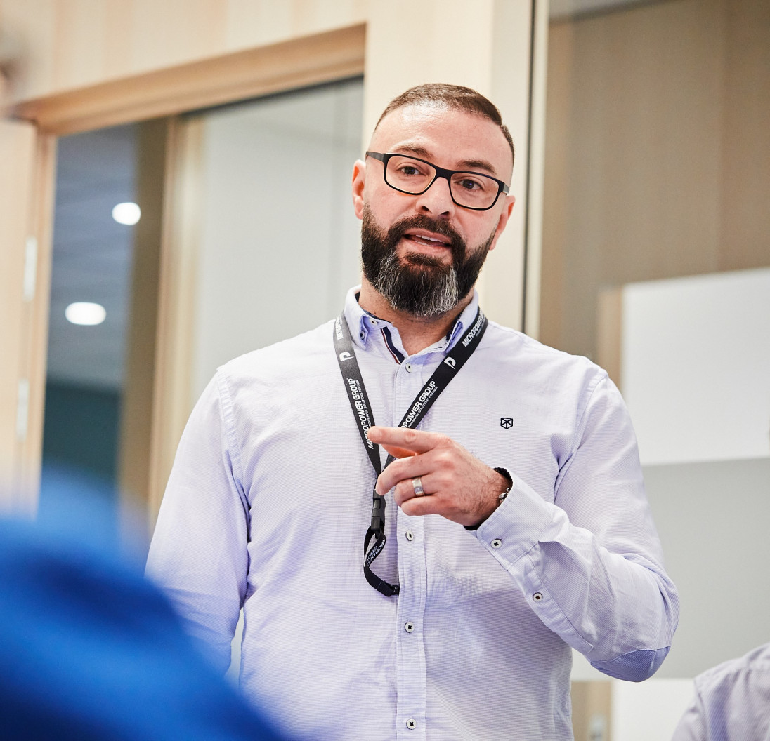 Employees speak in front of a group