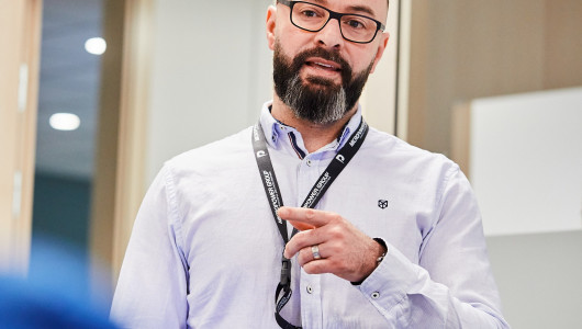 Employees speak in front of a group